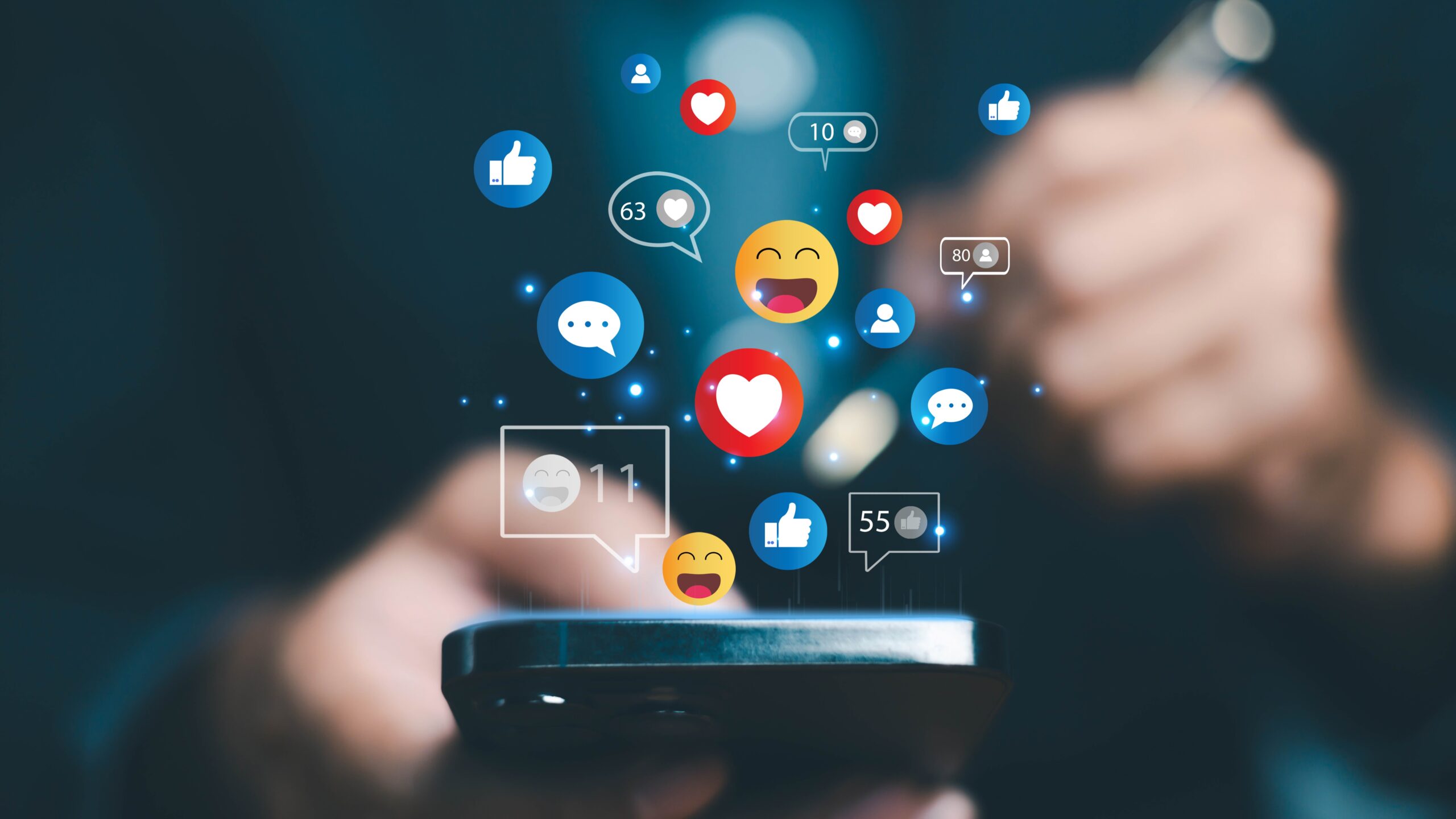 Hand holding a smartphone with floating social media icons including likes, hearts, comments, and engagement counters above the screen