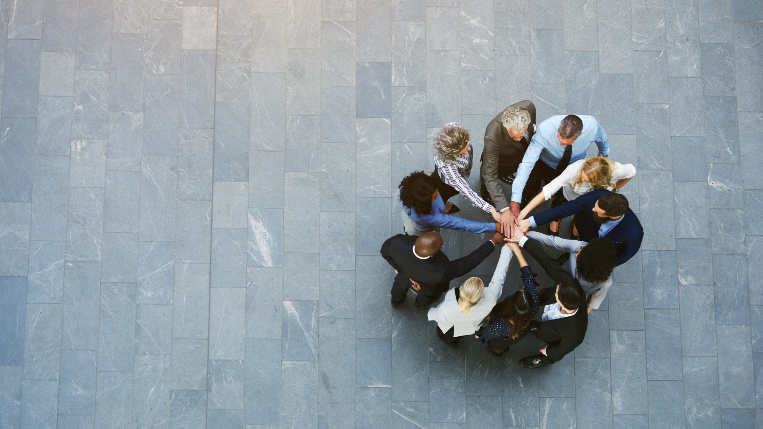 business team in circle with hands together